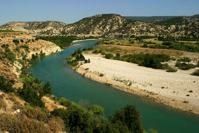 High angle view of river amidst trees against sky