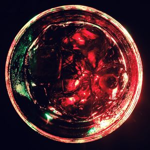 Close-up of lit candle against black background