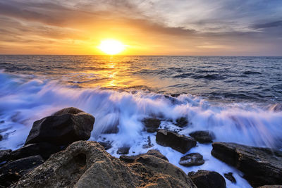 Scenic view of sea against sky during sunset