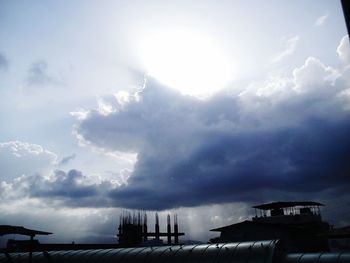 Low angle view of storm clouds in city