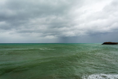Scenic view of sea against cloudy sky