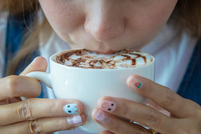 Close-up of young woman drinking coffee