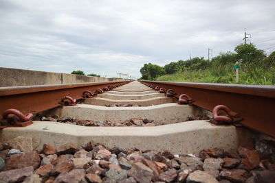 Surface level of railroad track against sky