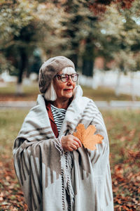 Man wearing mask in park during autumn