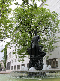 Statue against trees