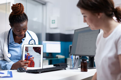 Side view of doctor working at office