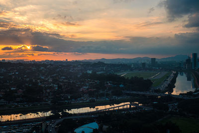 High angle view of bridge and buildings against sky during sunset