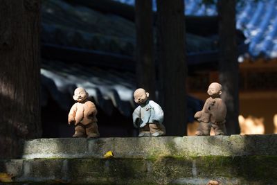 Statue against wooden wall