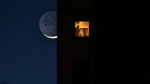 Low angle view of illuminated lamp against sky at night