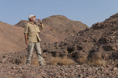 Full length of senior man standing in the desert 