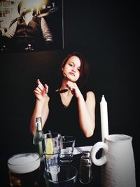Portrait of woman with drink on table