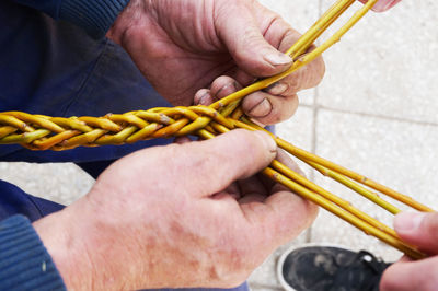 High angle view of people holding sticks outdoors