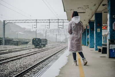 Woman walking on railroad station platform