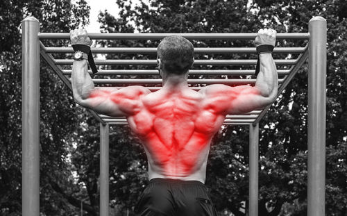 Rear view of man exercising in gym