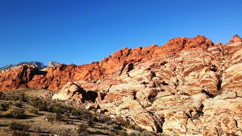 Scenic view of mountain against blue sky