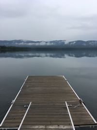 Pier over lake against sky