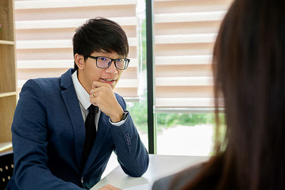 Businessman talking with colleague in office