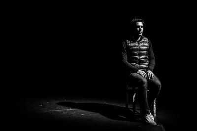 Close-up of illuminated lamp over black background