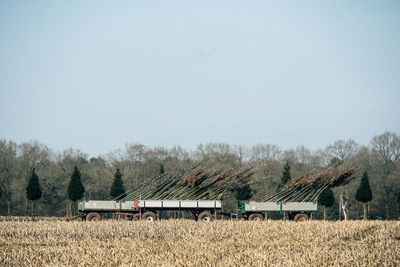 Tractor on field against clear sky