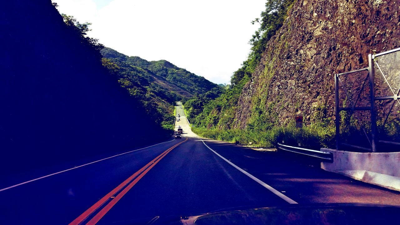 the way forward, clear sky, transportation, tree, road, mountain, diminishing perspective, vanishing point, road marking, railing, built structure, nature, long, copy space, tranquility, architecture, outdoors, blue, sky, day