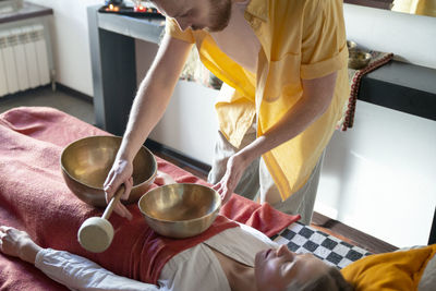 Midsection of man preparing food in kitchen