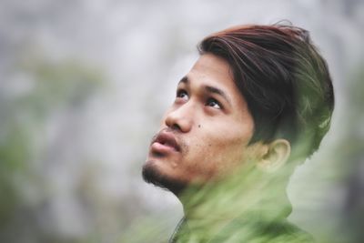 Portrait of young man looking away