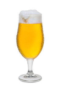 Close-up of beer glass against white background