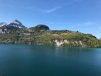 Scenic view of sea and mountains against sky