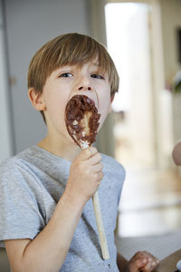 Boy licking whisk