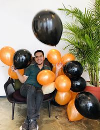 High angle view of men sitting on balloons