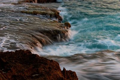 Waves splashing on rocks at beach