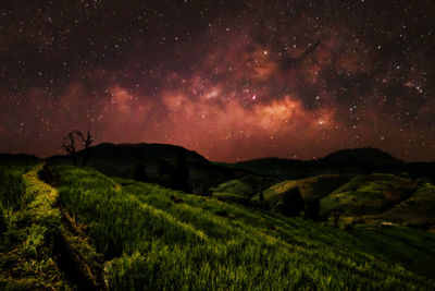 Scenic view of mountain against sky at night