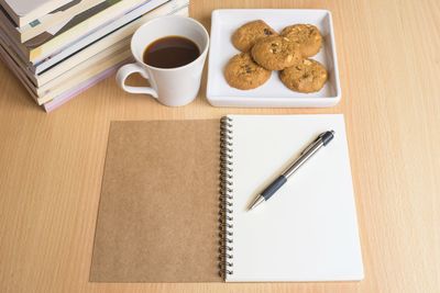 Directly above shot of coffee and book on table