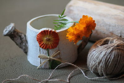 Close-up of orange flowers on table