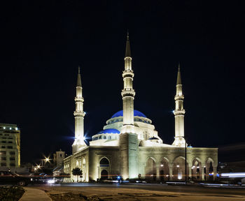 View of illuminated building against sky at night