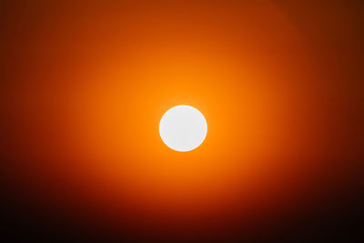 Low angle view of sun against orange sky