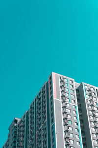 Low angle view of modern building against blue sky