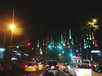 Cars on road in city at night