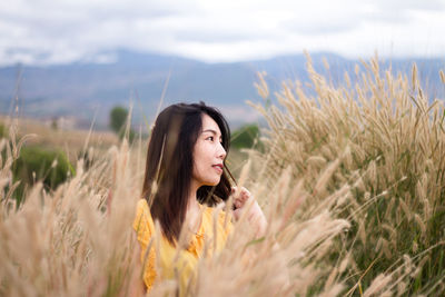 Young woman standing on field