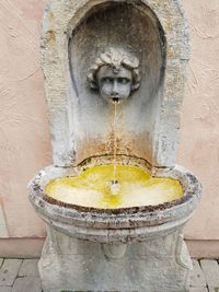 Statue of fountain against wall