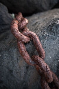 Close-up of rusty chain on rock