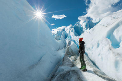 Person skiing on snowcapped mountain against sky