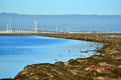 Scenic view of bay against clear sky