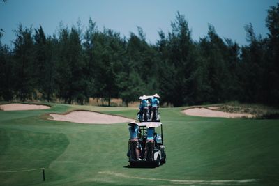 People on golf carts at playing field