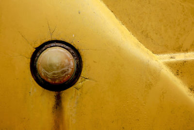 Full frame shot of abandoned yellow car headlight