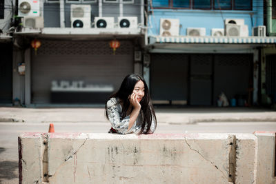 Portrait of beautiful woman in city