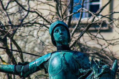 Low angle view of statue against trees
