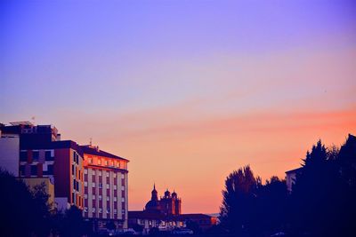 Low angle view of buildings at sunset