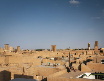 High angle view of buildings against blue sky