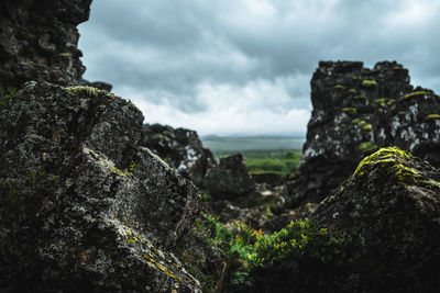 Close-up of rock formation against sky
